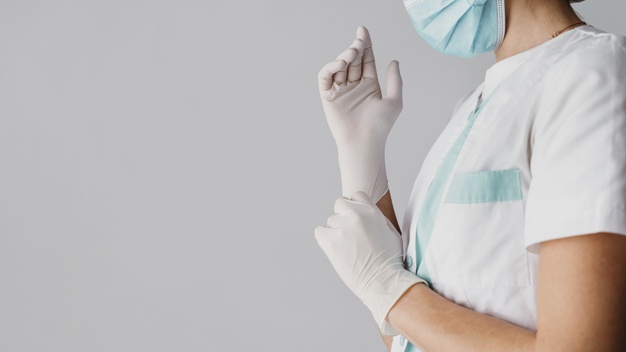 medico calcando luvas cirurgicas com espaco de copia