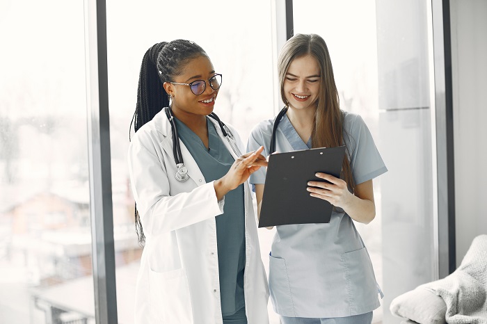 Two female doctors looking at an document