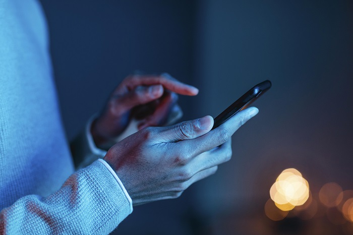 side view of man using smartphone