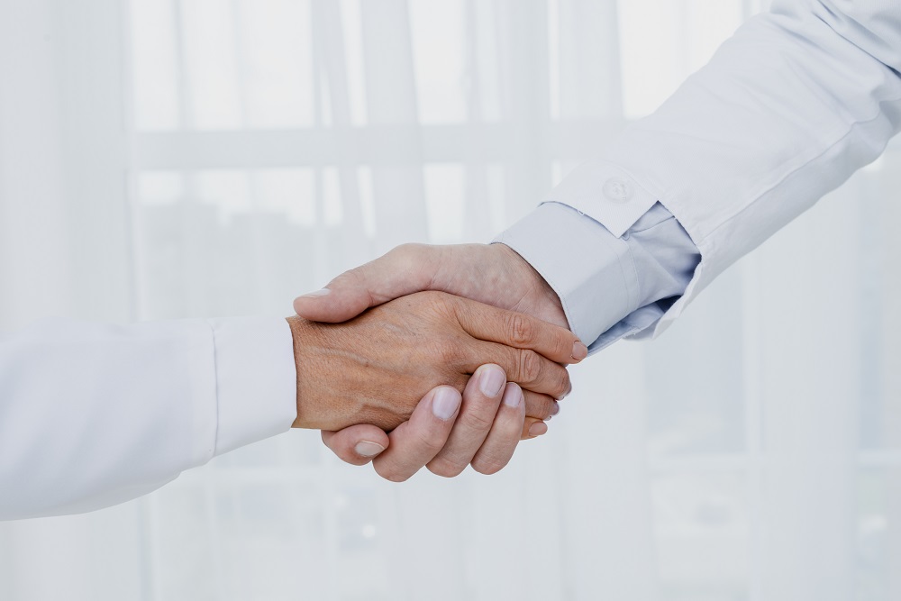close up doctors shaking hands
