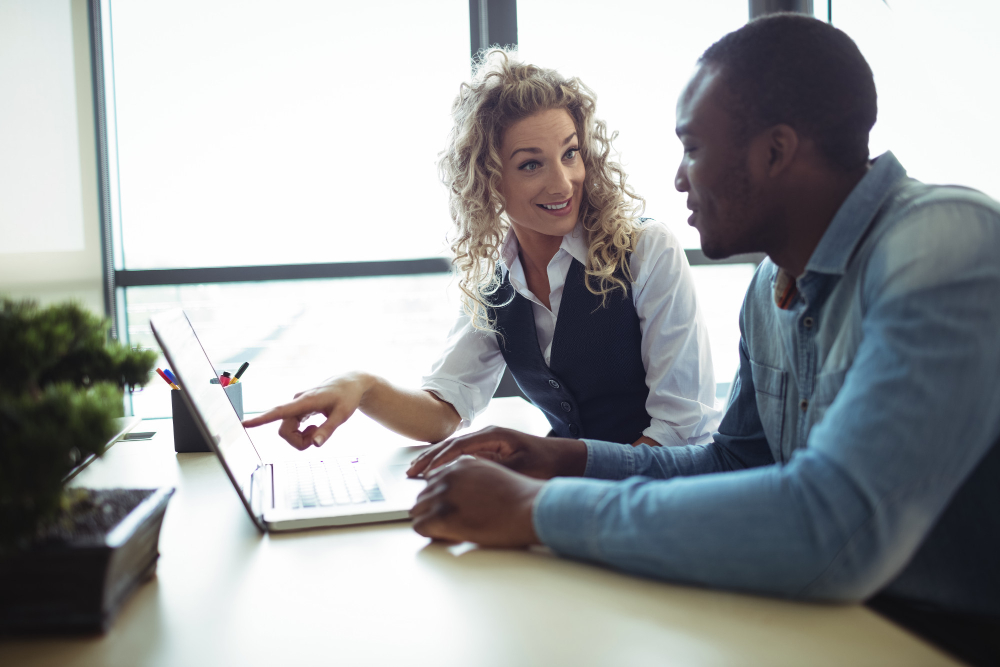 business executives discussing over laptop