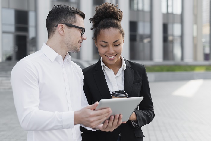 business man showing ipad to woman