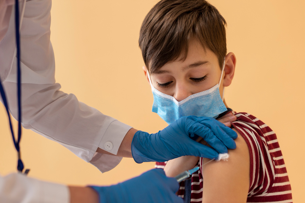 close up boy with mask getting vaccine
