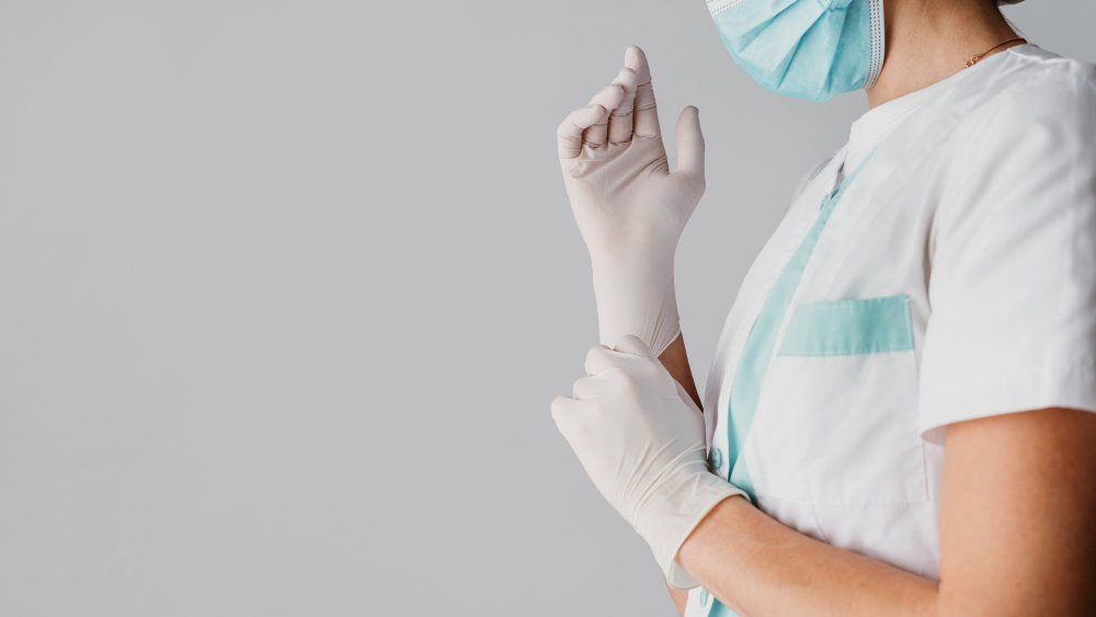 doctor putting on surgical gloves with copy space