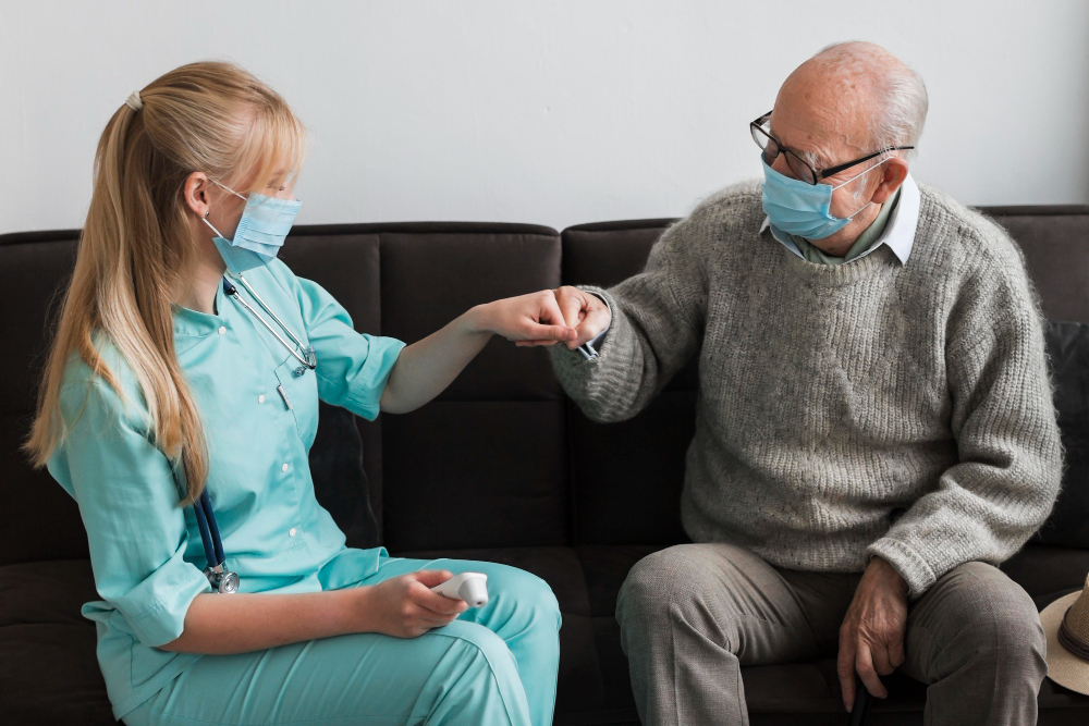 old man fist bumping nurse in a nursing home