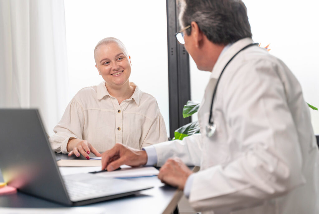 woman suffering of breast cancer talking with her doctor