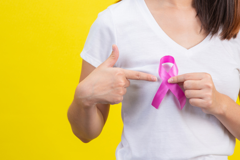 breast cancer a woman in a white t shirt with a satin pink ribbon on her chest a symbol for breast cancer awareness