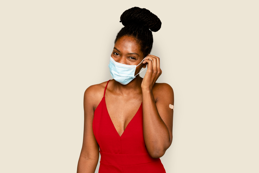 covid vaccinated woman taking off mask in the new normal