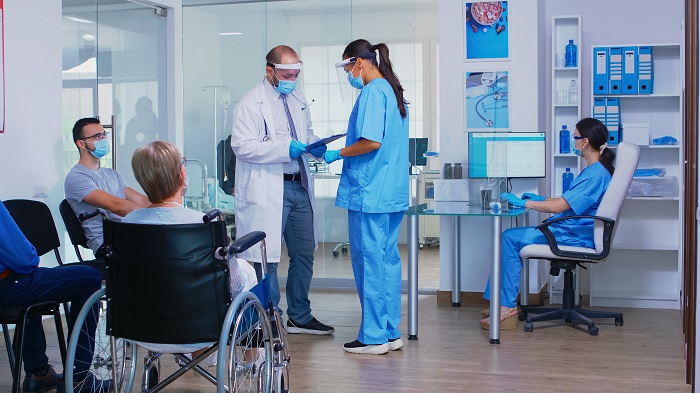 Discussing with nurse in hospital waiting area