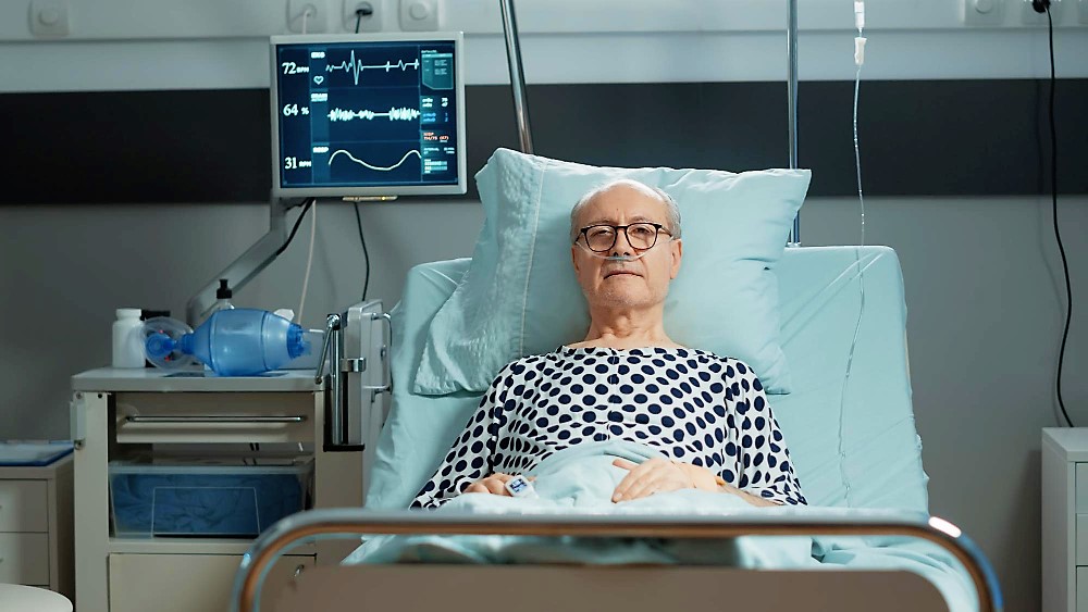 sick patient with nasal oxygen tube in hospital ward getting treatment to cure illness at clinic senior man receiving healthcare with help of modern medical equipment and medicine