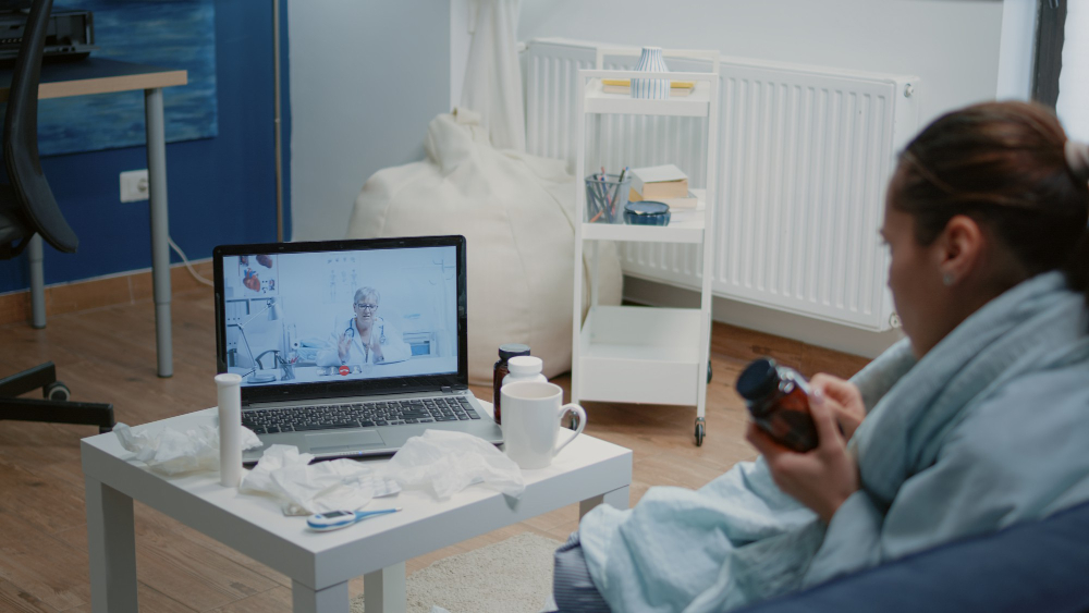 woman with cold and flu using video call for telemedicine