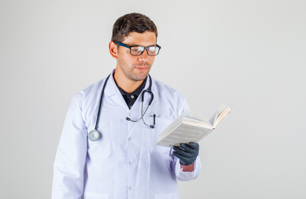 doctor reading book in medical white robe