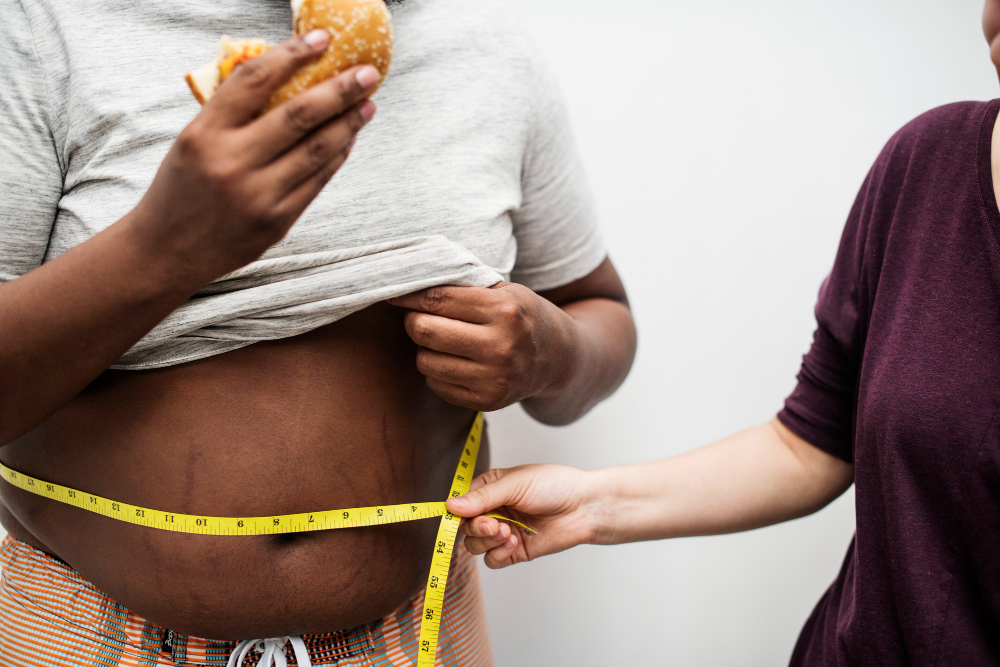 man eating a big hamburger