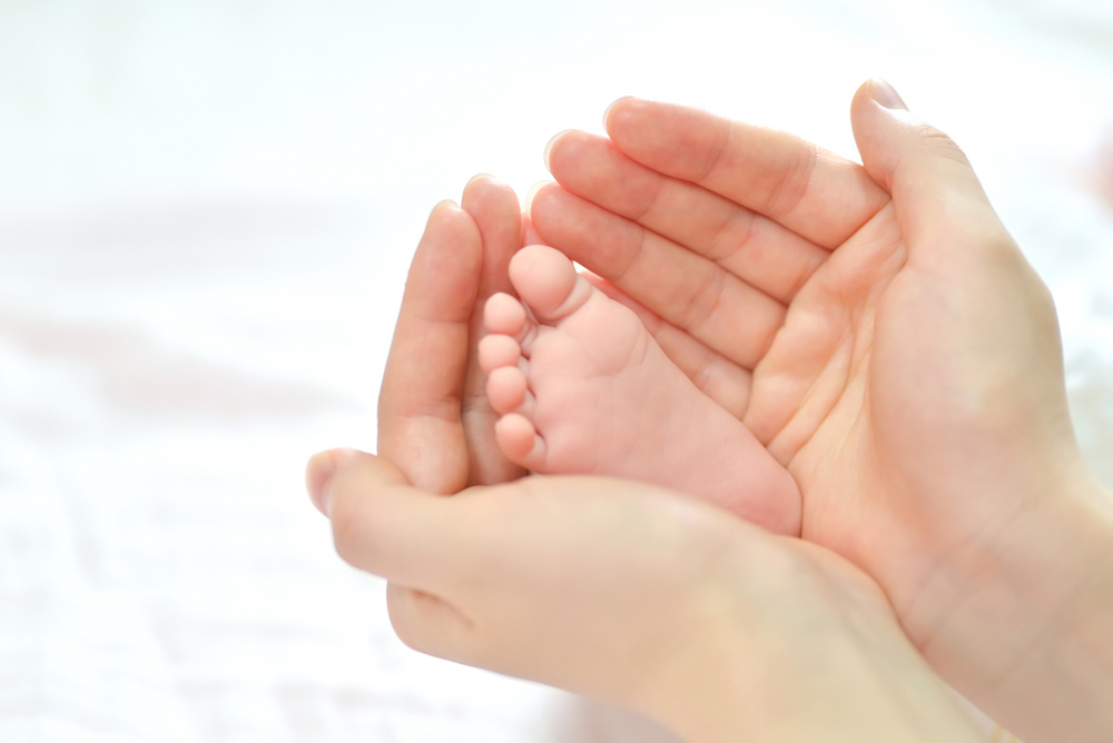baby feet in mother hands