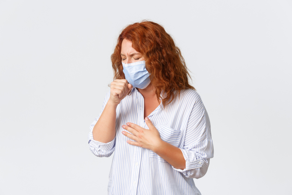 covid social distancing coronavirus self quarantine and people concept sick middle aged redhead woman coughing wearing medical mask having sour throat disease symptoms caught influenza
