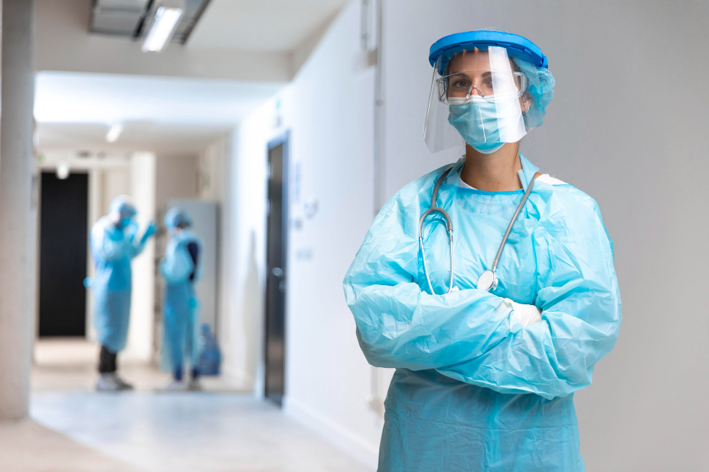 front view woman wearing protective wear in the hospital