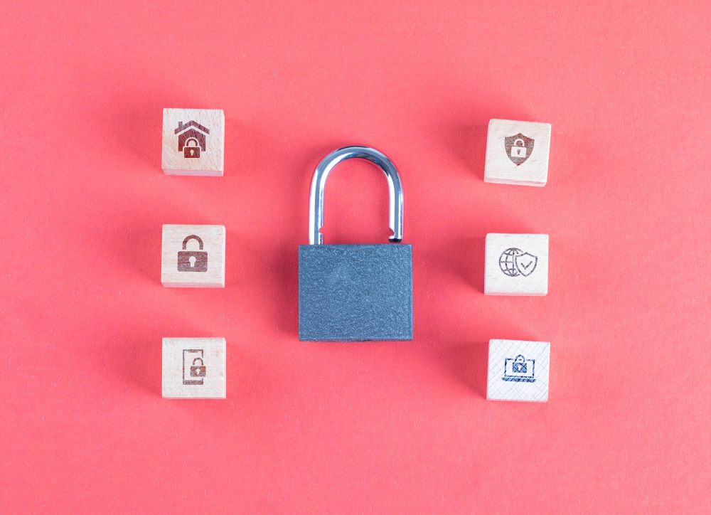 security concept with lock icons on wooden cubes on pink table flat lay