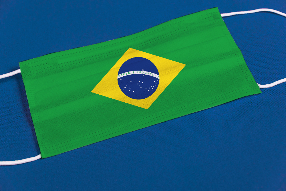 surgical mask on blue background with brazilian flag