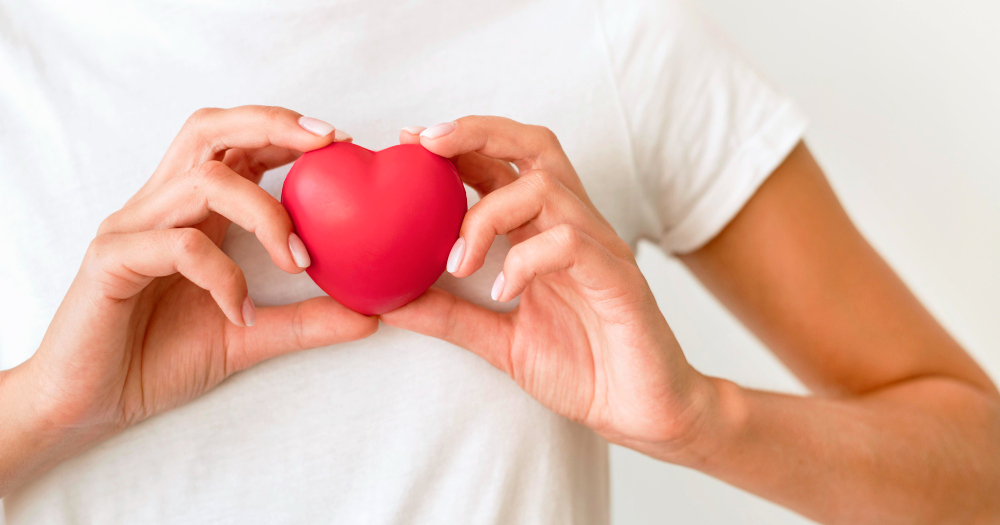front view of woman holding heart shape