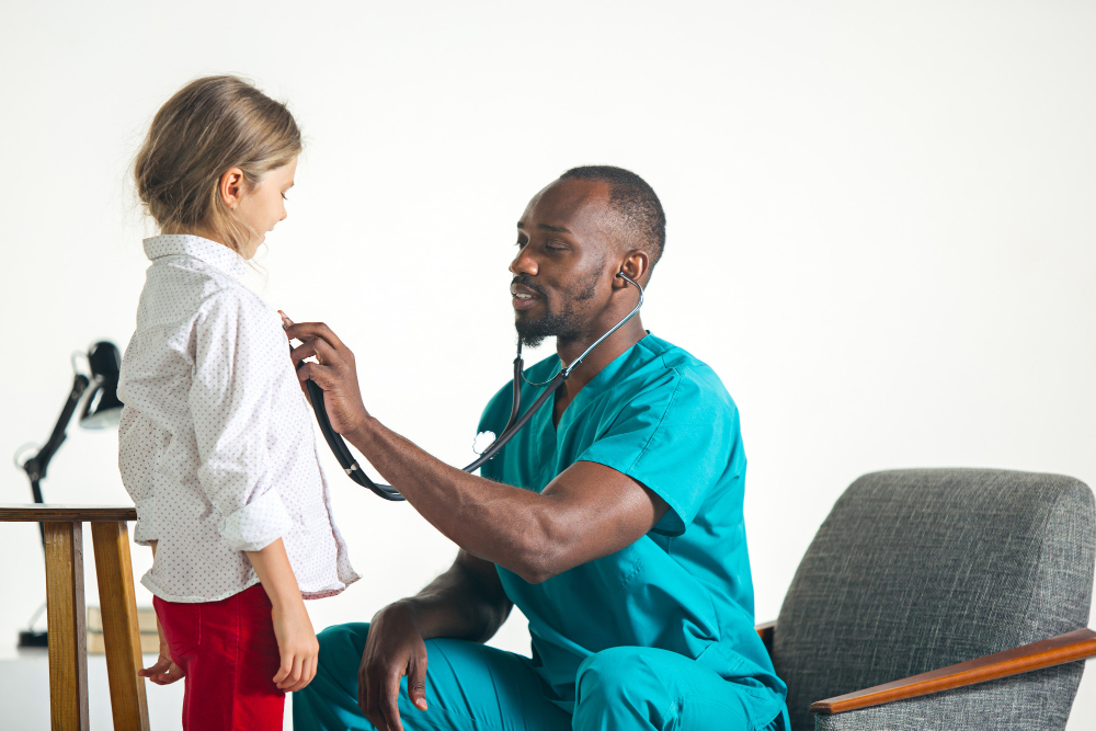 healthcare and medical concept doctor with stethoscope listening to child chest in hospital