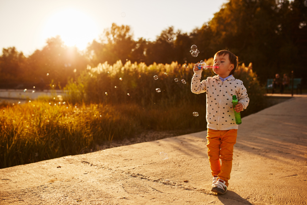 little boy playing with soap bubbles