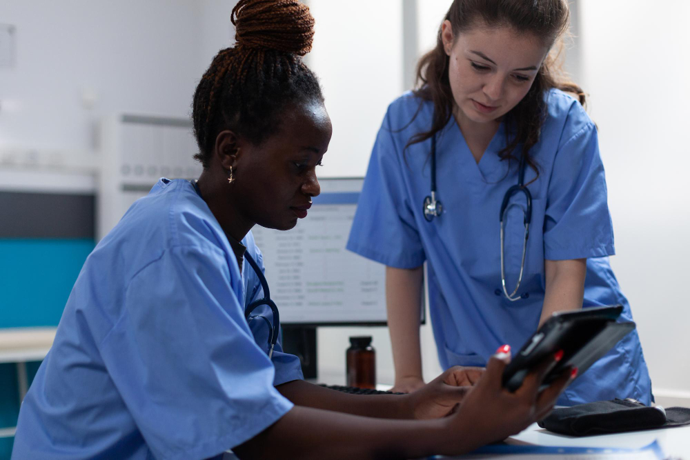 medical nurses analyzing disease symptoms discussing healthcare treatment working in hospital office teamworks checking pharmaceutical medication on tablet computer sitting at desk