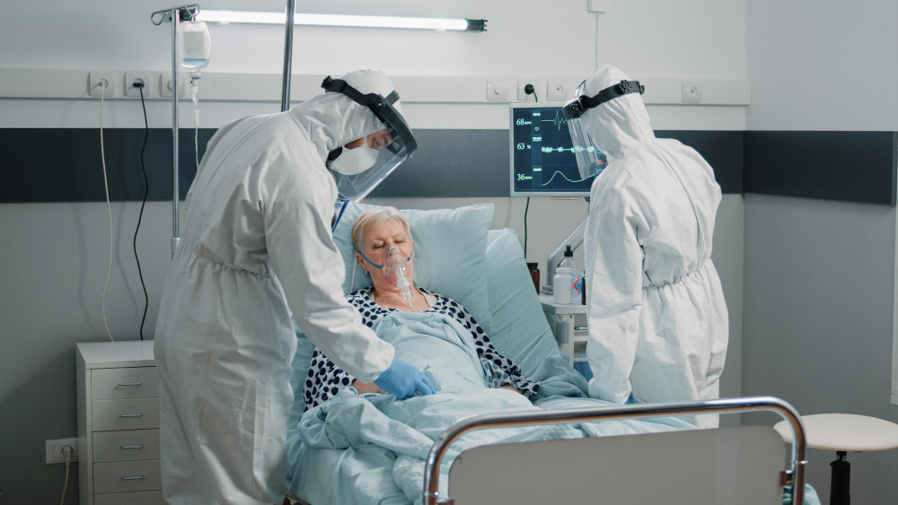 team of paramedics in hazmat suits checking on patient healthcare medical staff with protection against coronavirus outbreak consulting woman with oxygen tube in quarantine isolation zone