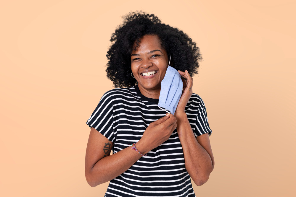 woman taking mask off during the new normal