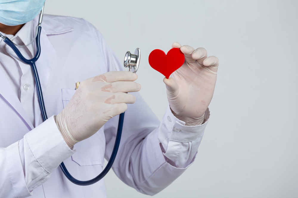 world diabetes day docter holding stethoscope and red heart wooden shape