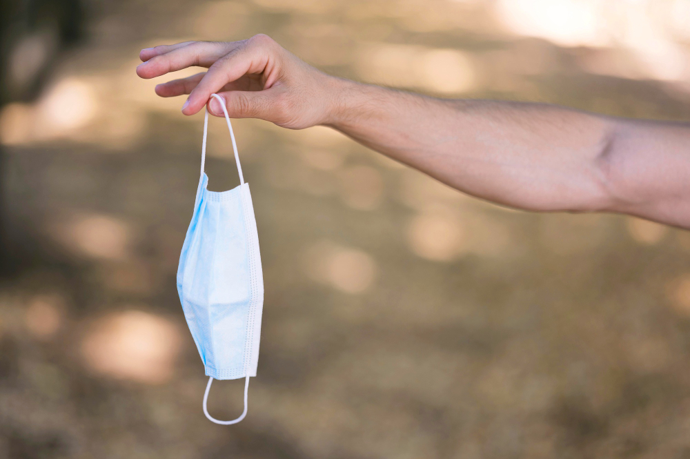 man holding his medical mask with copy space