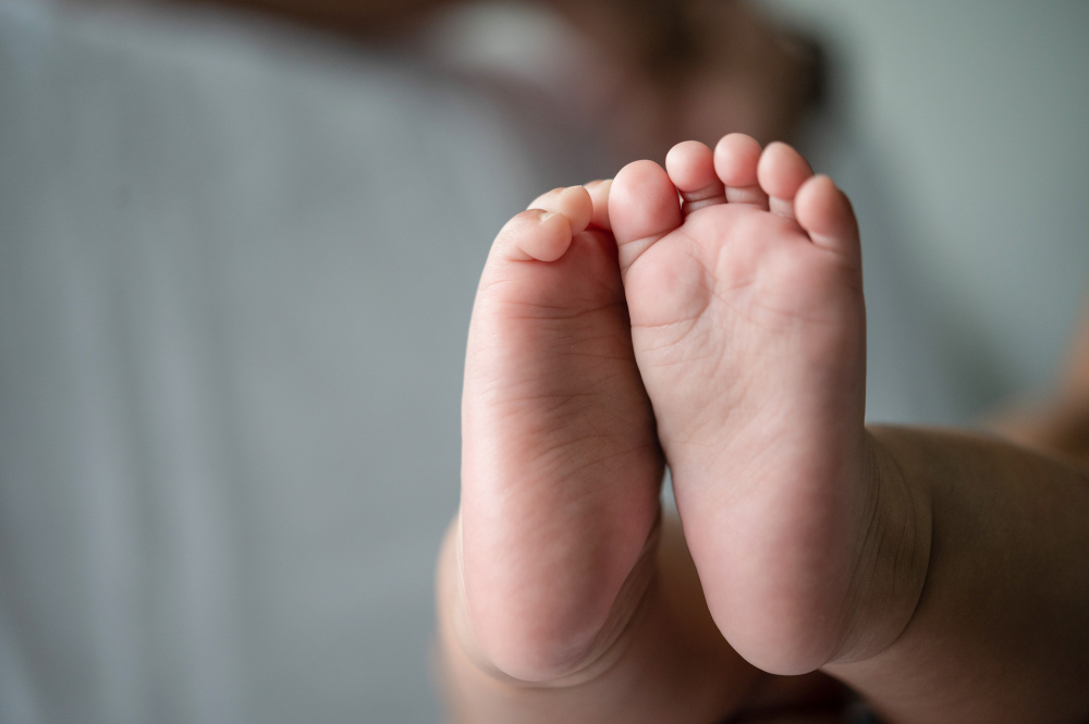 baby feet in white bed