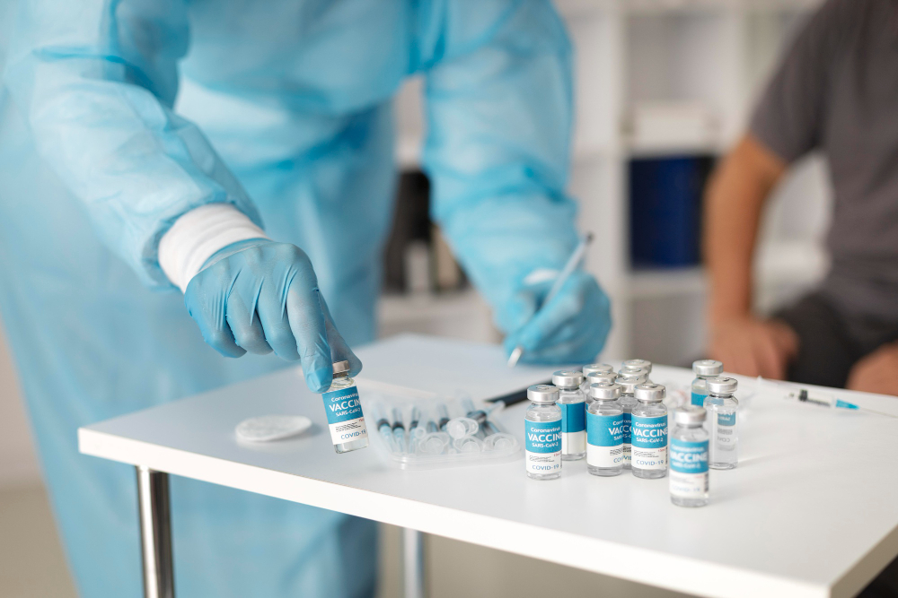 doctor in special equipment getting ready to vaccinate a patient