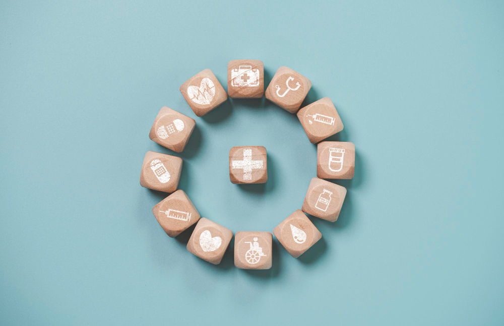 wooden block cube which print screen health care and medical icons for healthy and wellness concept