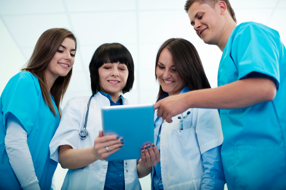 medical team checking results on digital tablet