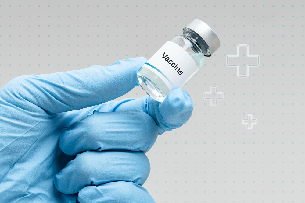 hand in medical glove holding vaccine vial