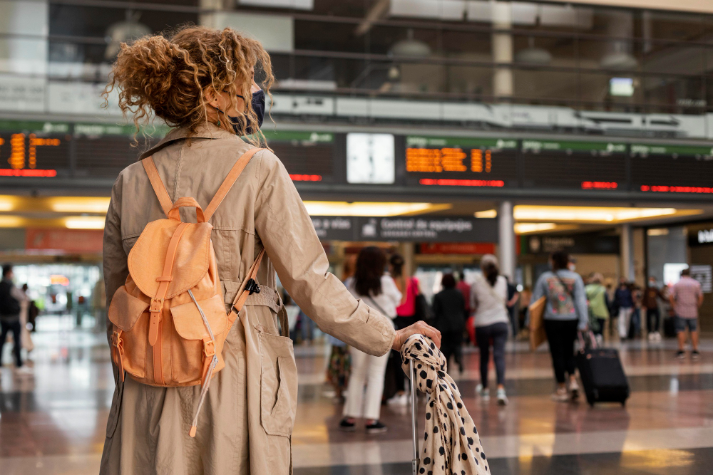medium shot woman traveling with mask