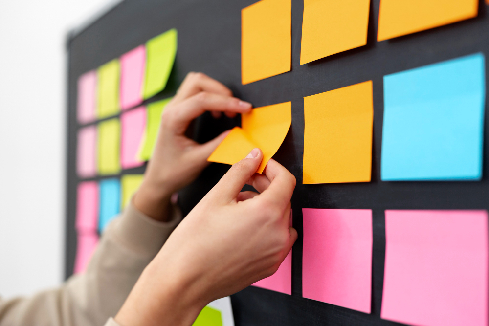 side view hands sticking yellow post it