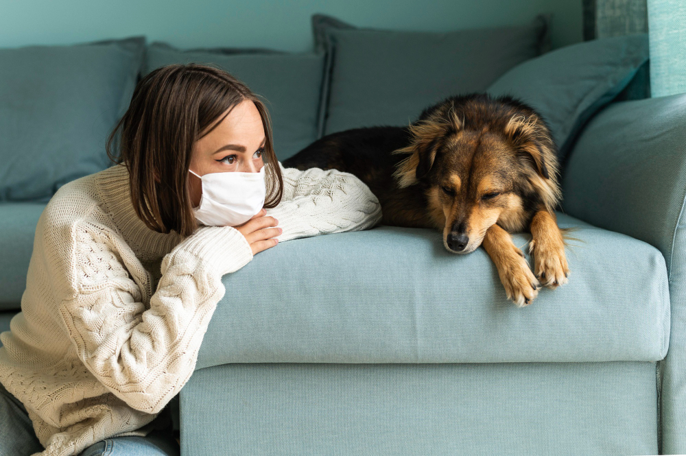 woman sitting next to her dog at home during the pandemic