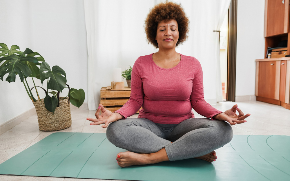 african senior woman doing yoga session home focus face
