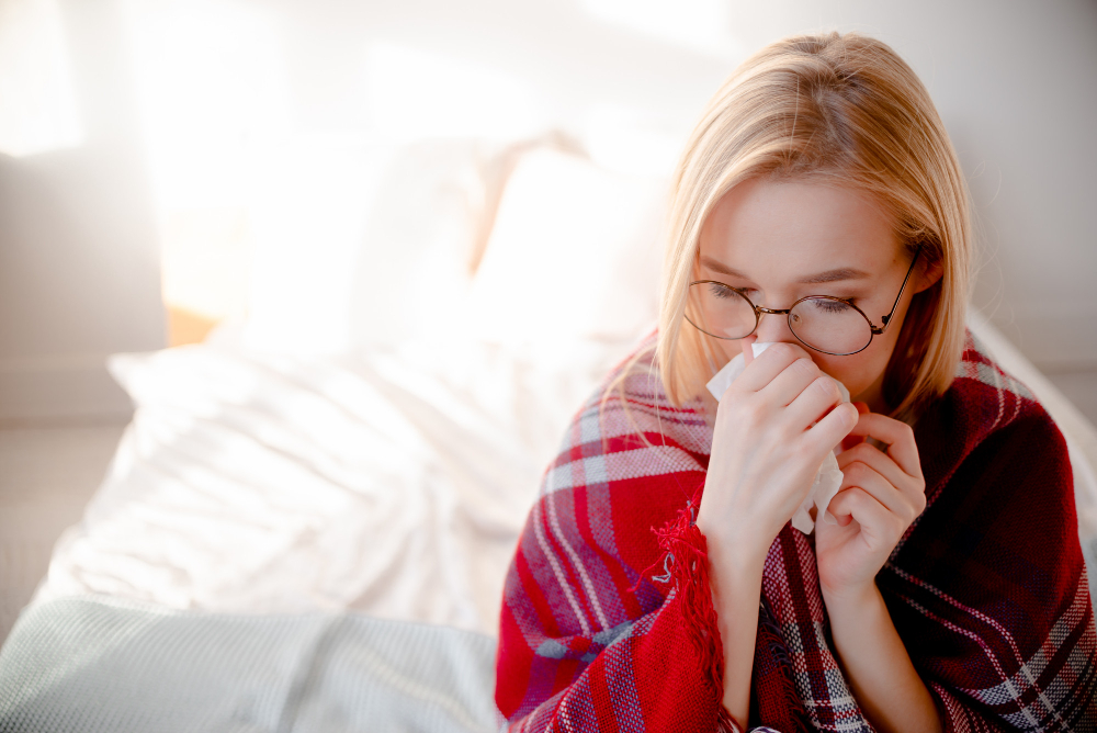 blond woman having cold and blocked nose helth care and allergy treatment concept top horizontal view copyspace coronavirus symptoms
