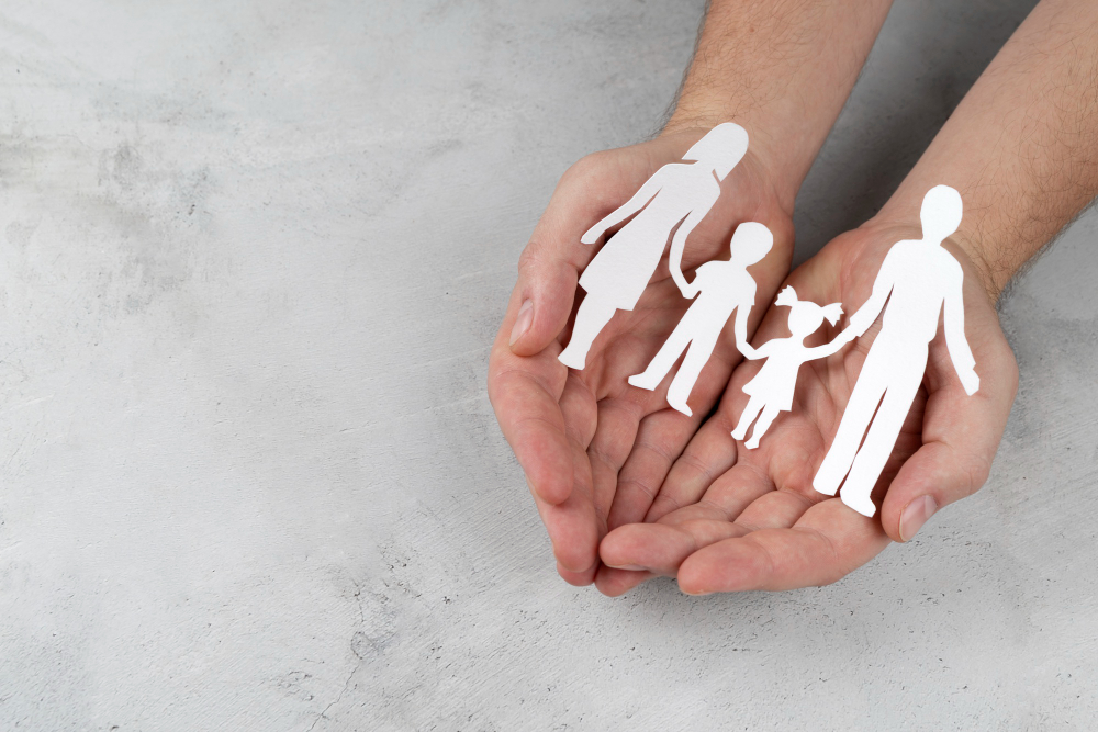 close up hands holding paper family