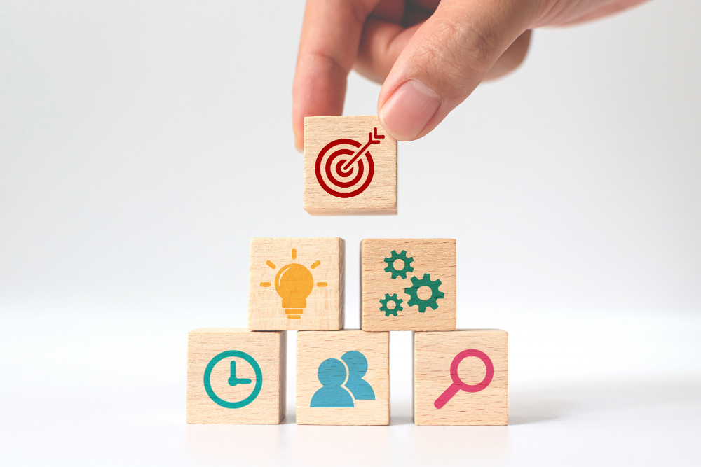 concept of business strategy and action plan hand putting wooden cube block stacking with icon