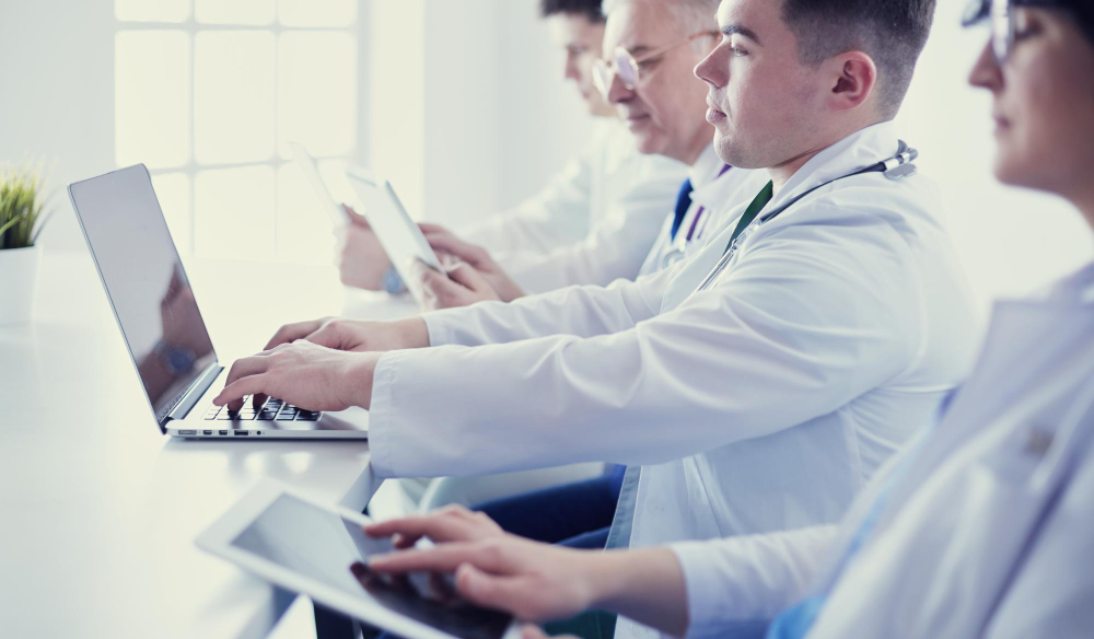 medical team sitting discussing table
