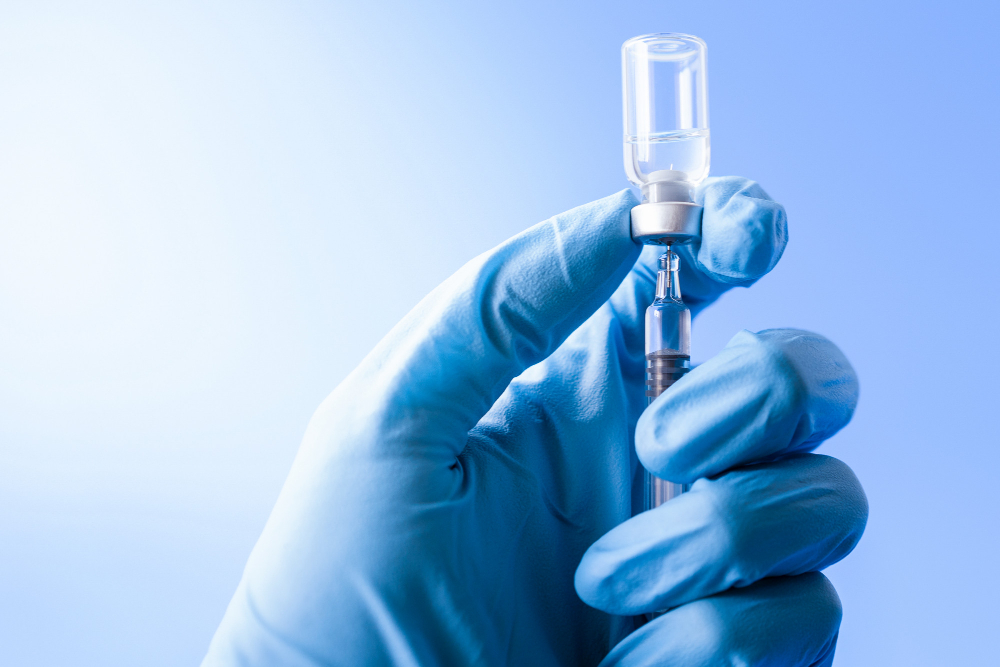 doctor hand holding flu vaccine