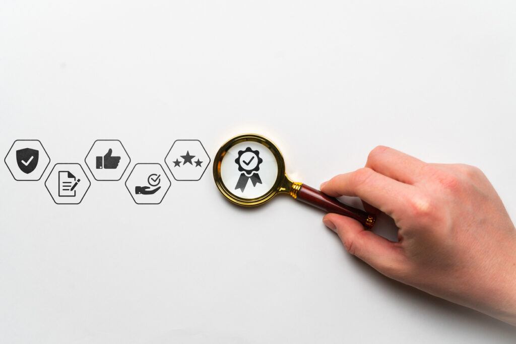 Quality research concept with thematic icons Hand holds a magnifying glass