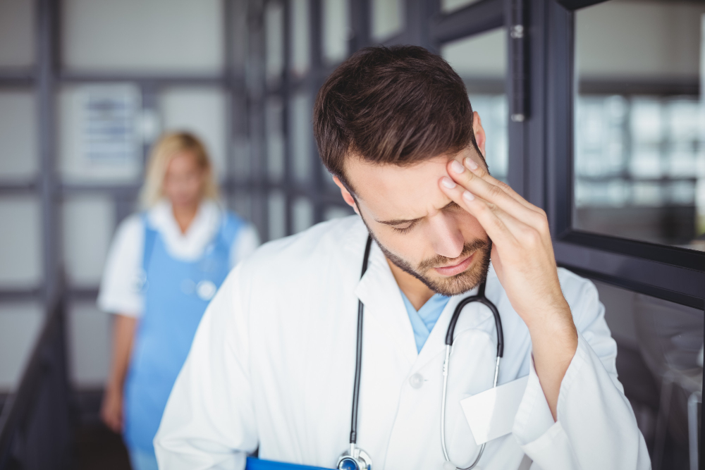 male doctor suffering from headache