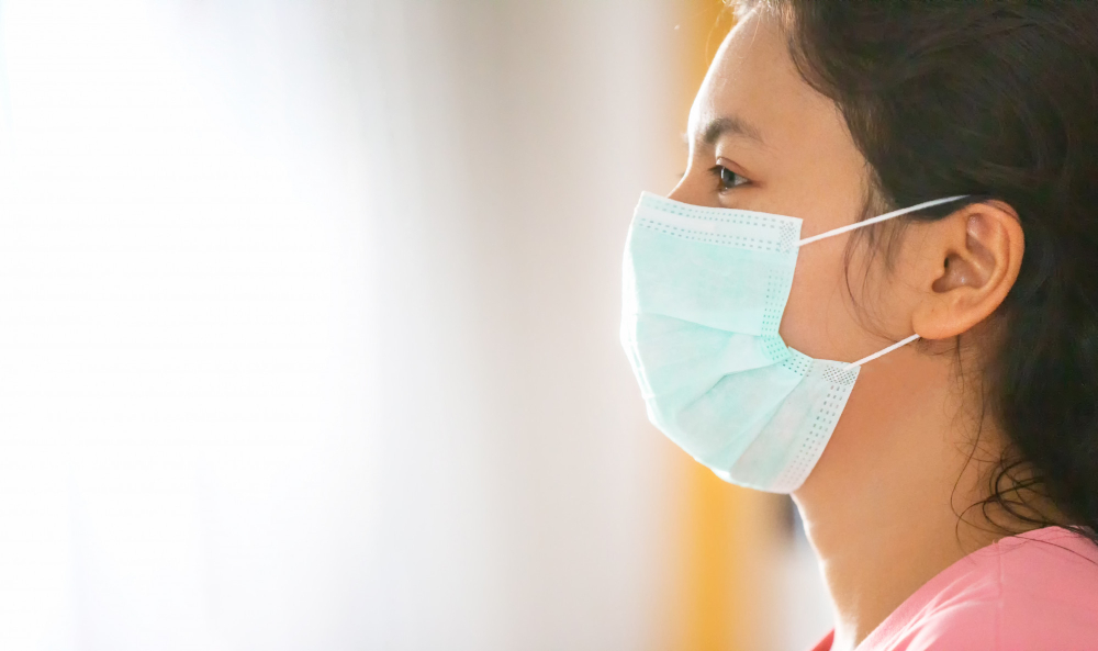 side view of woman wear mask to protect covid virus spreading on the air