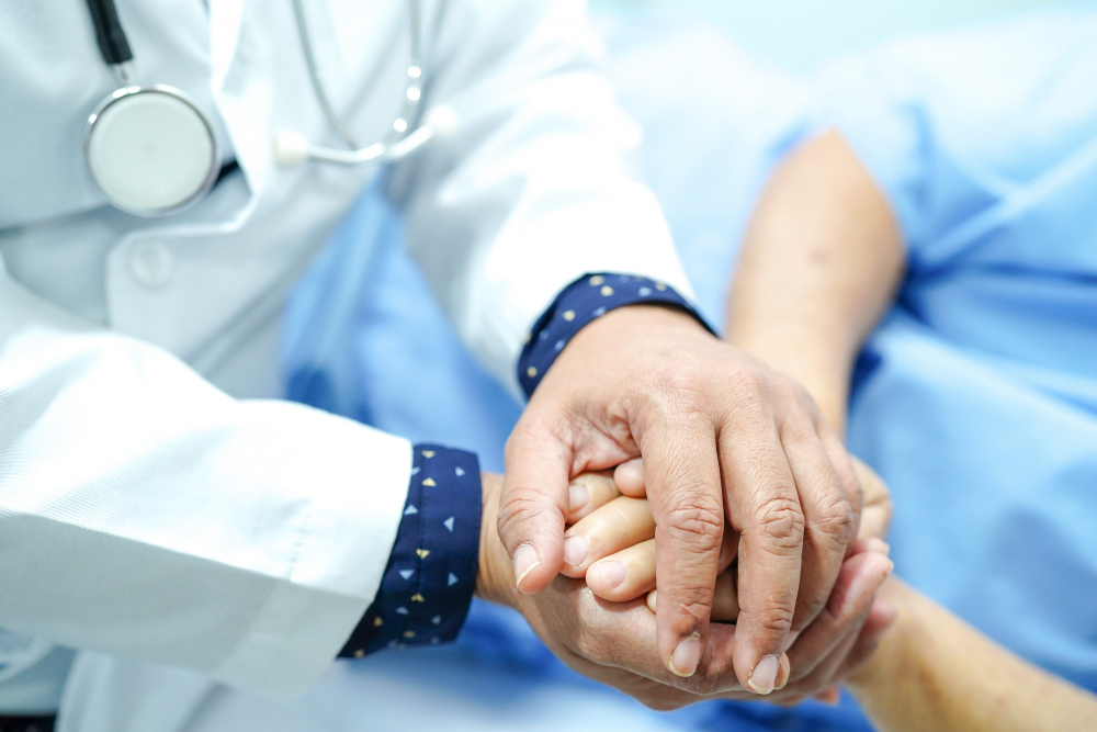 doctor holding touching hands asian senior old lady woman patient with love care and empa