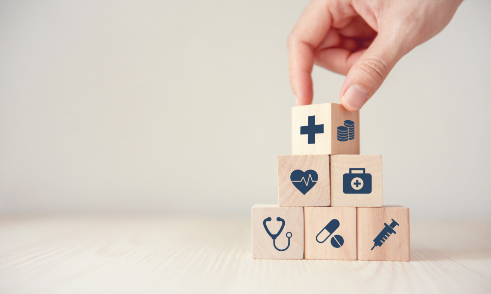 health insurance concept reduce medical expenses hand flip wood cube with icon healthcare medical and coin on wood background copy space