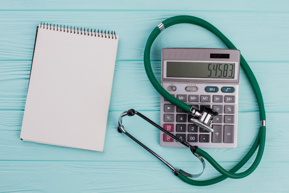 flat lay medical composition include calculator notepad stethoscope blue pastel background white blank notepad from top view